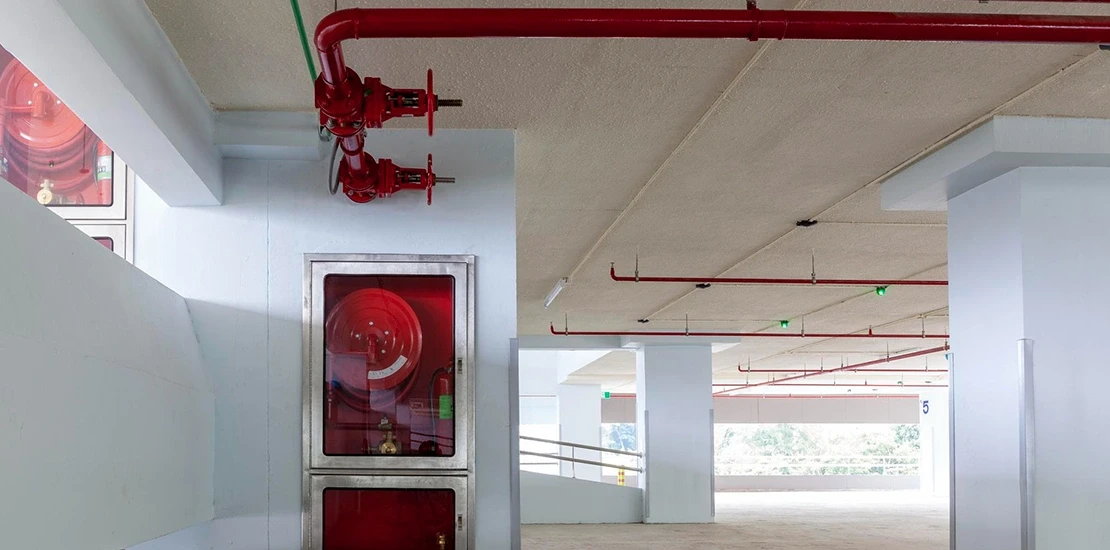 Fire alarm system company technician inspecting a control panel